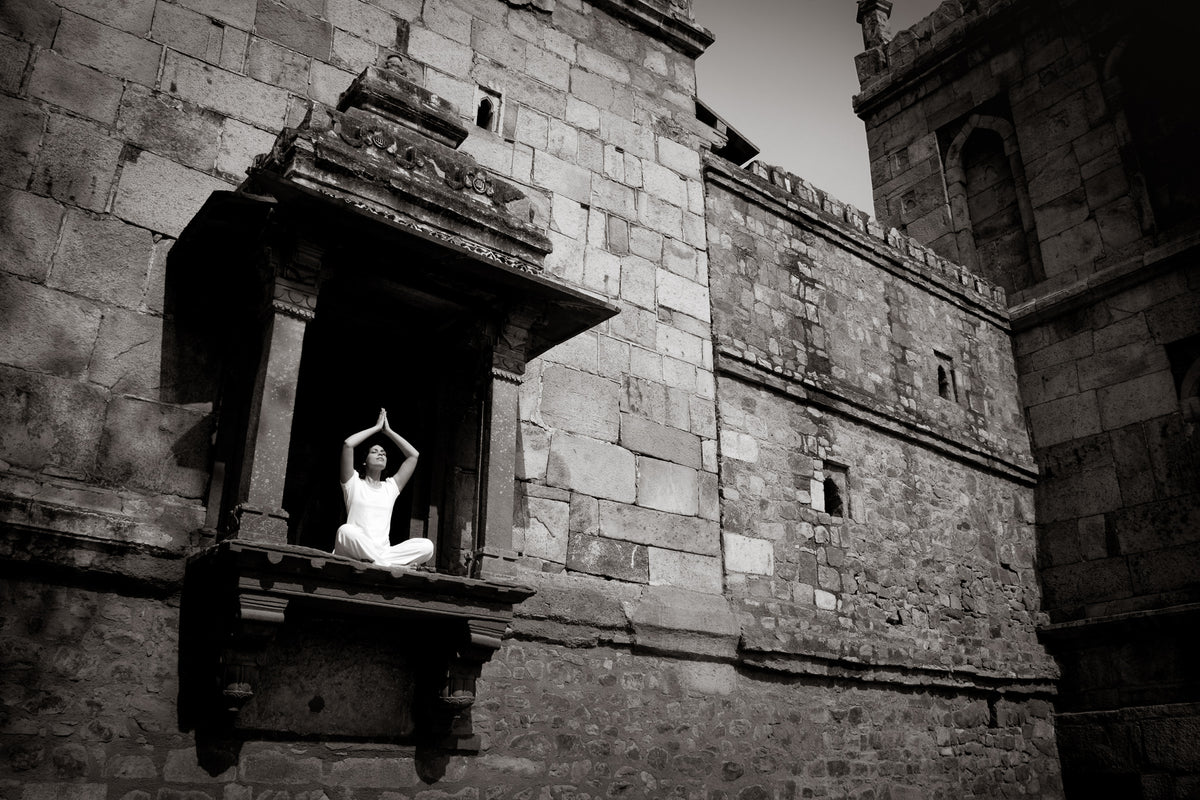 A woman in white does yoga in Lodhi Gardens, New Delhi, India. (Gallery Print)