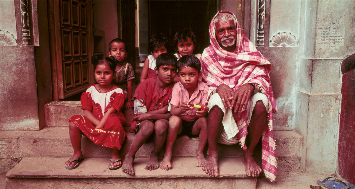 Elderly man and children sitting on their steps.  Banaras, India. (Gallery Print)