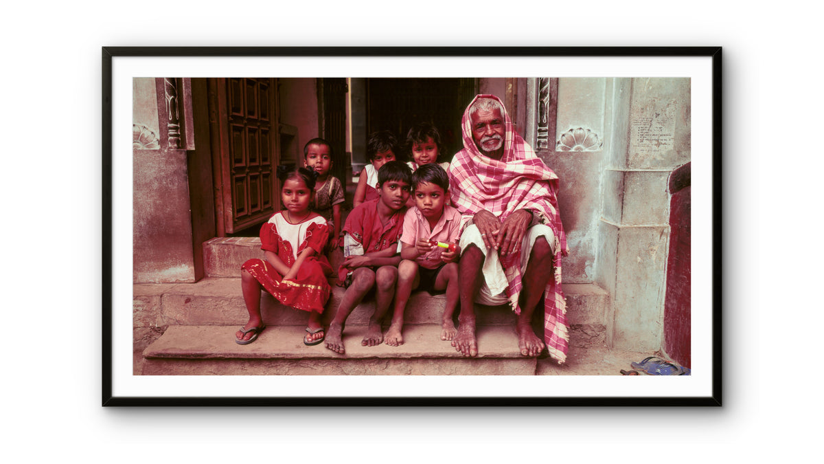 Elderly man and children sitting on their steps.  Banaras, India.