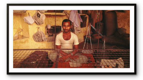 A man in a provisions shop.  Banaras, India.
