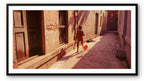 A child with a kite attempts to get it airborne.  Banaras, India.