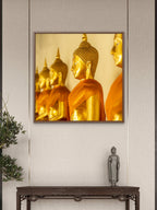 Golden Buddhas in soffron robes.  Wat Pho, Bangkok, Thailand.