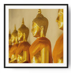 Golden Buddhas in soffron robes.  Wat Pho, Bangkok, Thailand.
